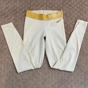 Tan Nike pro pants with gold